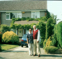 The Morgans  in front of their old house.